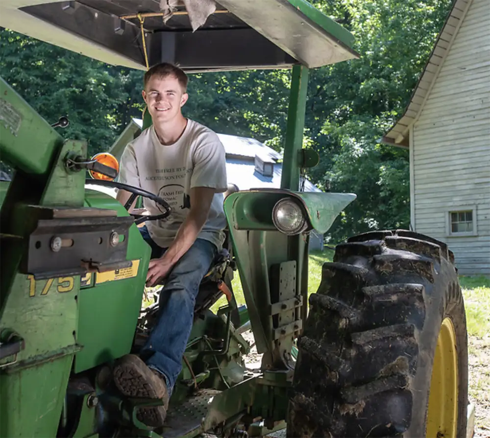 Young farmer driving a tractor